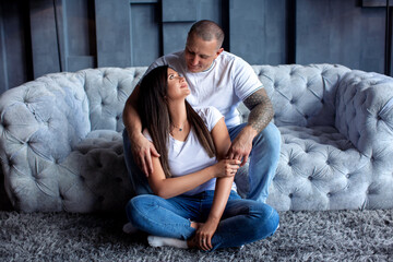 Full size portrait of cheerful positive couple enjoying time together in modern apartments wearing denim clothes. Daydream happiness pleasure home party concept