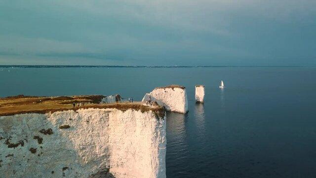 Aerial view of the white cliffs of Old Harry Rocks lit by the late afternoon Sunlight in Studland, Dorset, United Kingdom.