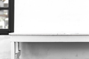 Long white wooden bench and white cement wall