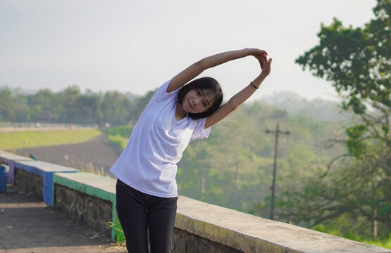 Young Asian woman has  streaching before doing jogging and running in the morning