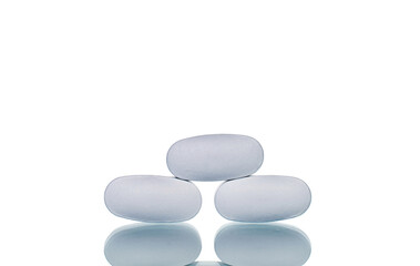Fototapeta na wymiar Several vitamin tablets, close-up, isolated on white.