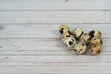 A few quail eggs isolated on a table. Selective focus points