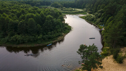 Fototapeta na wymiar Aerial top view river, forest and beach. Gorgeous aerial panoramic view on the touristic part of the river Berezina in Belarus.