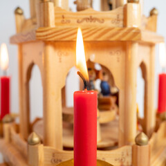 Burning candles at the Christmas pyramid.