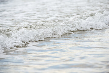 Fototapeta na wymiar Close up of waves on the shore of a beach