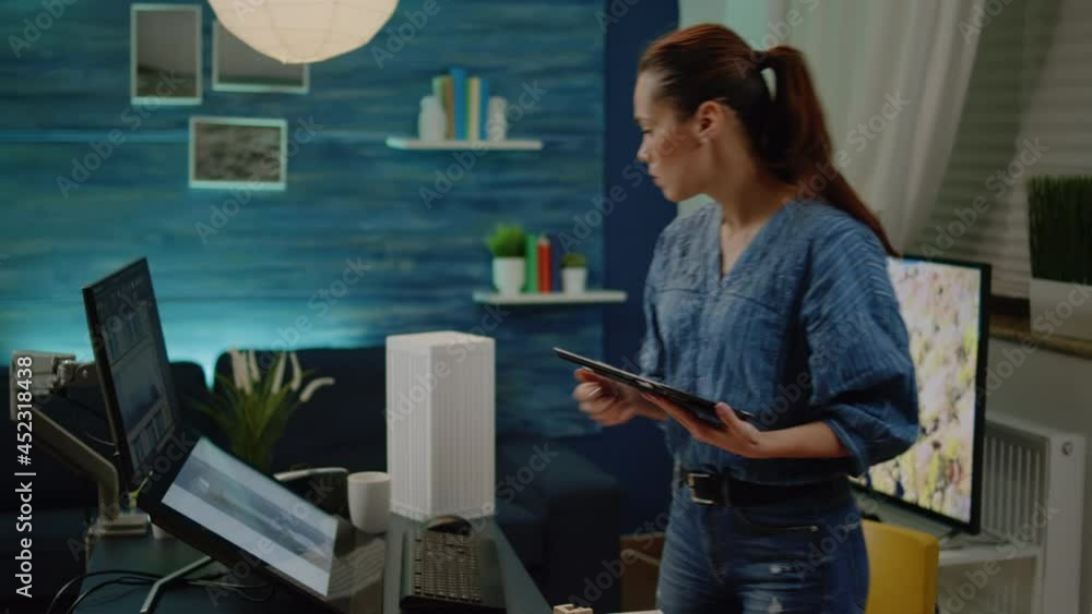 Poster woman architect holding tablet analyzing blueprint and maquette on table. construction planner using