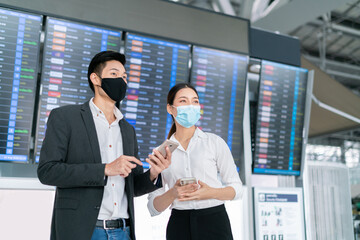 New normal and social distancing concept.Businessman and businesswoman wearing face mask meeting...