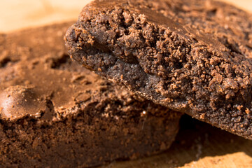 Pieces of fresh brownie on wooden background. Delicious chocolate pie. Macro Close-up. Selective focus.