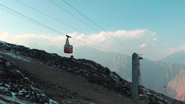 Aerial view of the cable car in Negi's Waichin Camps, a mountain top with snow at sunset, Kullu, Himachal Pradesh, c.