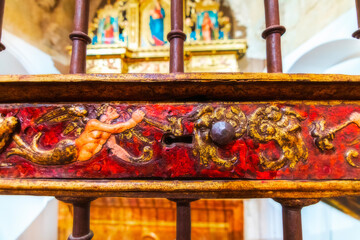 Detail view of the carved and painted metal sculpture grids of the ancient religious cathedral of Cuenca, World Heritage City, Spain.