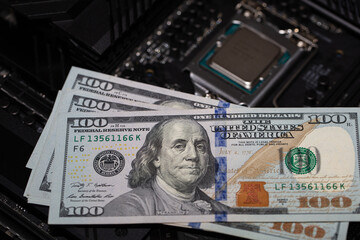 100 dollar banknotes on motherboard