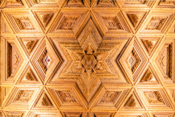 Obraz premium View of the ceiling of a chapel carved in wood with geometric shapes of the interior of the old religious cathedral of Cuenca at sunset, World Heritage City, Spain.