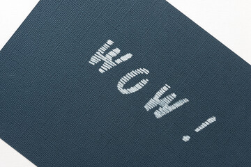 the word "wow" stencilled on dark blue paper background with a bit of white showing through