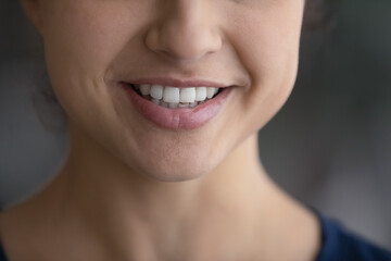 Crop close up of smiling young Indian woman show healthy white event teeth after good quality dental treatment at dentistry. Happy mixed race female talk communicate. Oralcare, diversity concept.