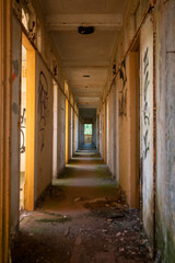 crumbling creepy abandoned corridor with pockets of light