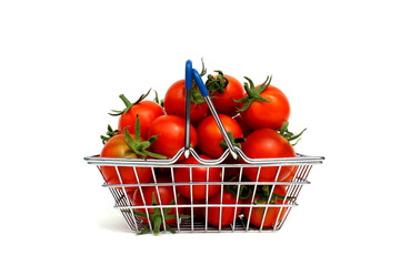 Full shopping basket with red ripe tomatoes on a white isolated background.