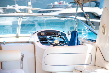 Steering wheel on expensive luxury yacht cabin. Detail of the interior of yacht. © yalcinsonat