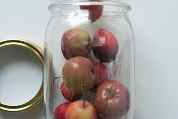 still life with crab apples in a clear jar with ring-lid