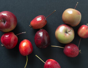 close up of crab apples on a black background