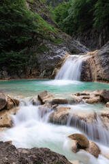 Fototapeta na wymiar Scenic Blue Waterfall in the Green Frost