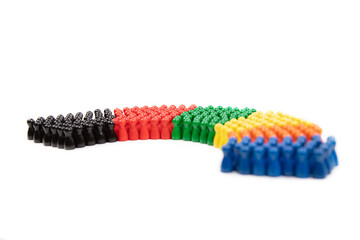 wooden figurines in the colors of German political parties and the rotunda of the german parliament