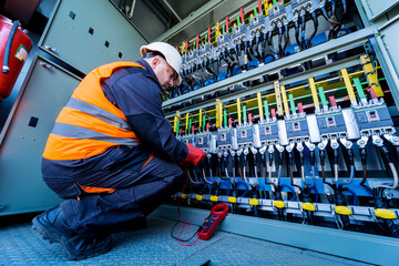Checking the operating voltage levels of the solar panel switchgear compartment