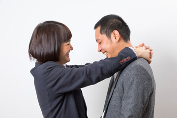 Asians executive businessman and businesswoman smile and hugging standing on white background.