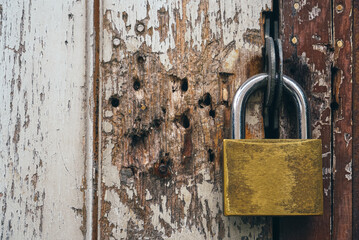 Old padlock on a wooden door                     