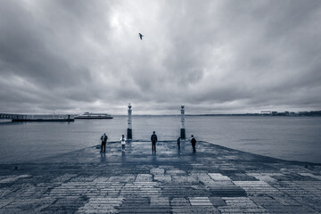 Bad weather in Lisbon. River Tagus. Old town embankment near Commerce Square. Portugal