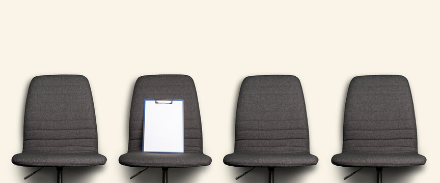 clean clipboard lies on a gray office chair against a light background. Banner