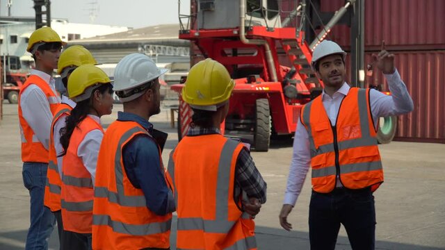manager training group of asian foreman and worker in morning meeting  before entering start working in industrial loading container box at warehouse logistic cargo import export shipping business