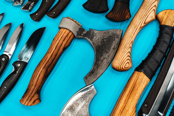 Axes and knives in a retro style on the counter in the store. Close-up