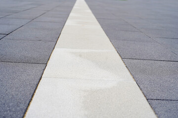 Fragment of granite paving stones with special markings for people with disabilities. Close-up