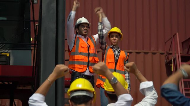 harbor Workers protest in Cargo freight ship for import export logistic over container box warehouse . Group of protestors shouting get out and  fists raised up . woman  Strike of labor in industry