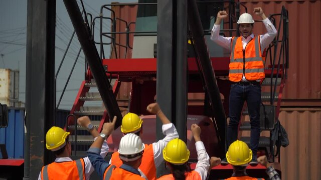 harbor Workers protest in Cargo  freight ship for import export logistic over container box warehouse . Group of protestors shouting and  fists raised up in the air . Strike of labor in industry