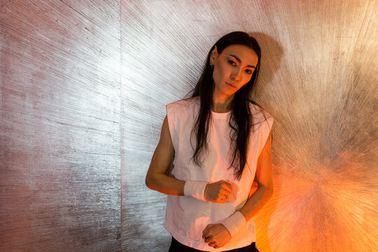 Asian androgynous man with long hair posing