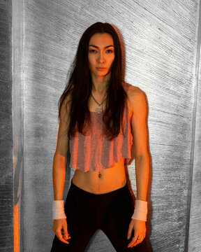 Asian androgynous man with long hair posing