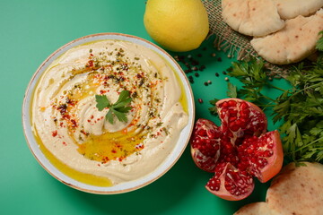 Hummus with olive oil, paprika, lemon and pita bread