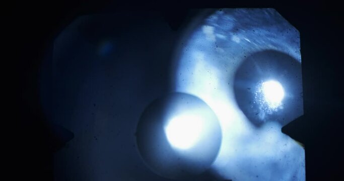 Light beam through the viewfinder of an old medium format film camera. Light leaks. Psychedelic and surreal background.
