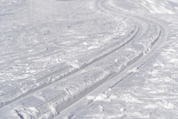 Fototapeta na wymiar Cross-country skiing Tracks on clear snow in winter suny day. winter sport skiing trucks