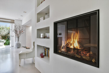 Stylish fireplace in a spacious living room - obrazy, fototapety, plakaty