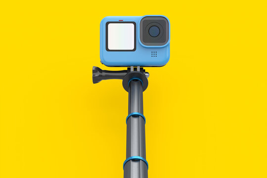 Photo and video lightweight action camera with monopod on yellow background
