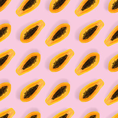 Fresh ripe papaya seamless pattern on pink background. Tropical abstract background. Top view. Creative design, minimal flat lay concept. Trend tropical fruit food background pattern