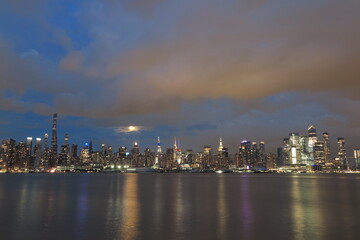Fototapeta premium Beautiful Manhattan night view and moon seen from New Jersey