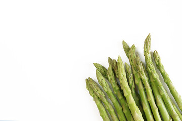 Young green asparagus on a white background. Vegetables. Vegetarian food. Shoots, asparagus sprouts. Healthy food. The concept of cooking. Food background.