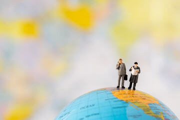Miniature Business man people office worker stand on globe world map thinking business plan solve problem using for Accounting Financial Banking business growth development and Commerce Strategy Plan