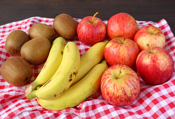 Pile of Fresh Ripe Assorted Fruits on Checkered Table Cloth for the Concept of WELLNESS