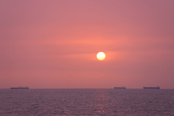 Sunrise at sea with ships