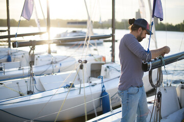 Preparation for the regatta at the yachting school at the marina with sailing yachts.