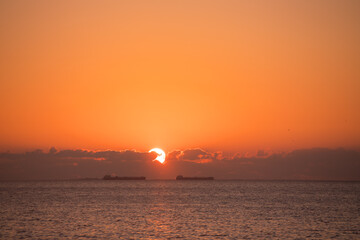Fototapeta na wymiar Sunrise at sea with ships